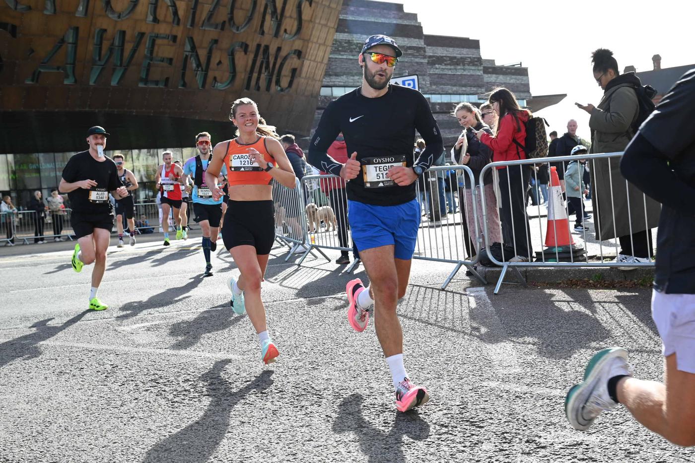 Runners passing the Wales Millennium Centre during the Cardiff Half Marathon